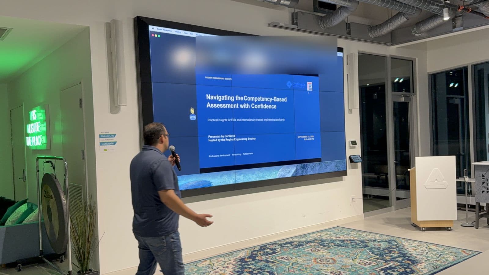 A CertNova co-founder presenting in front of the session's title slide in Regina
